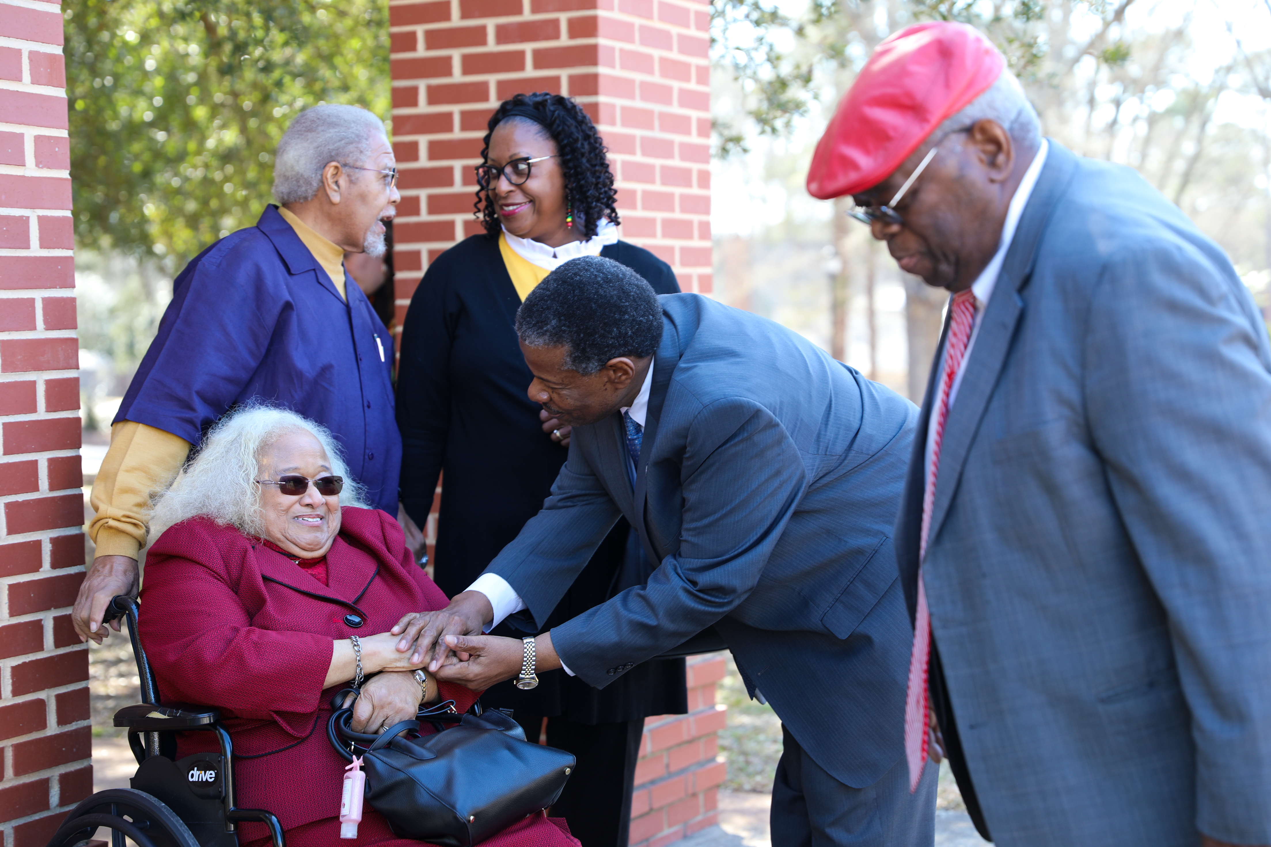Dr. Ronald Rhames shakes hands with Sandra Jackson