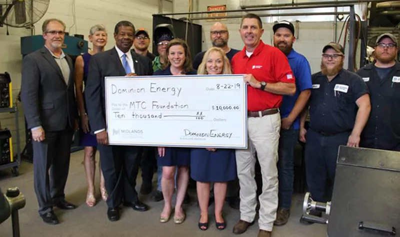 Group of people holding $10,000 check from Dominion Energy