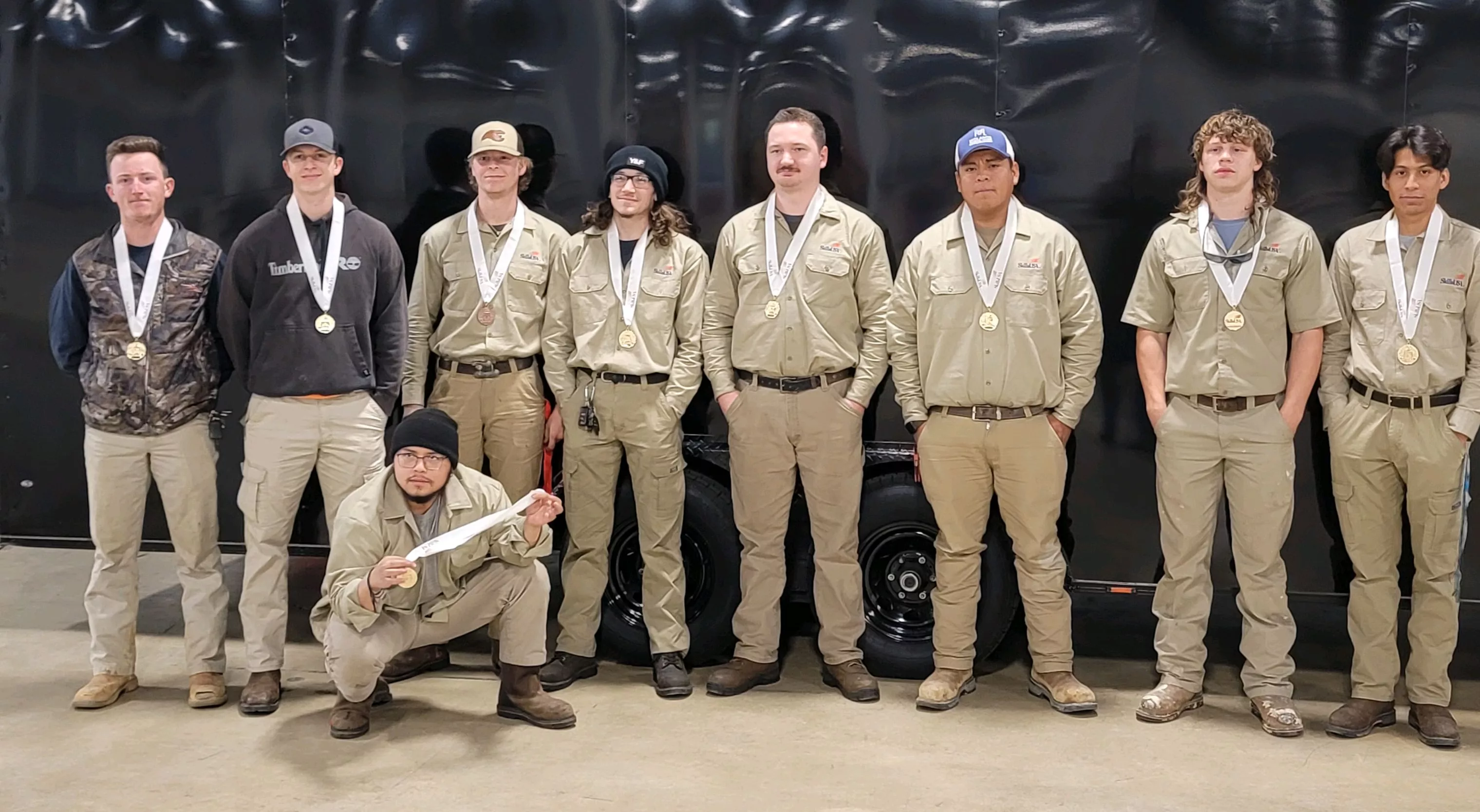 Building Construction Team standing together with their medals.