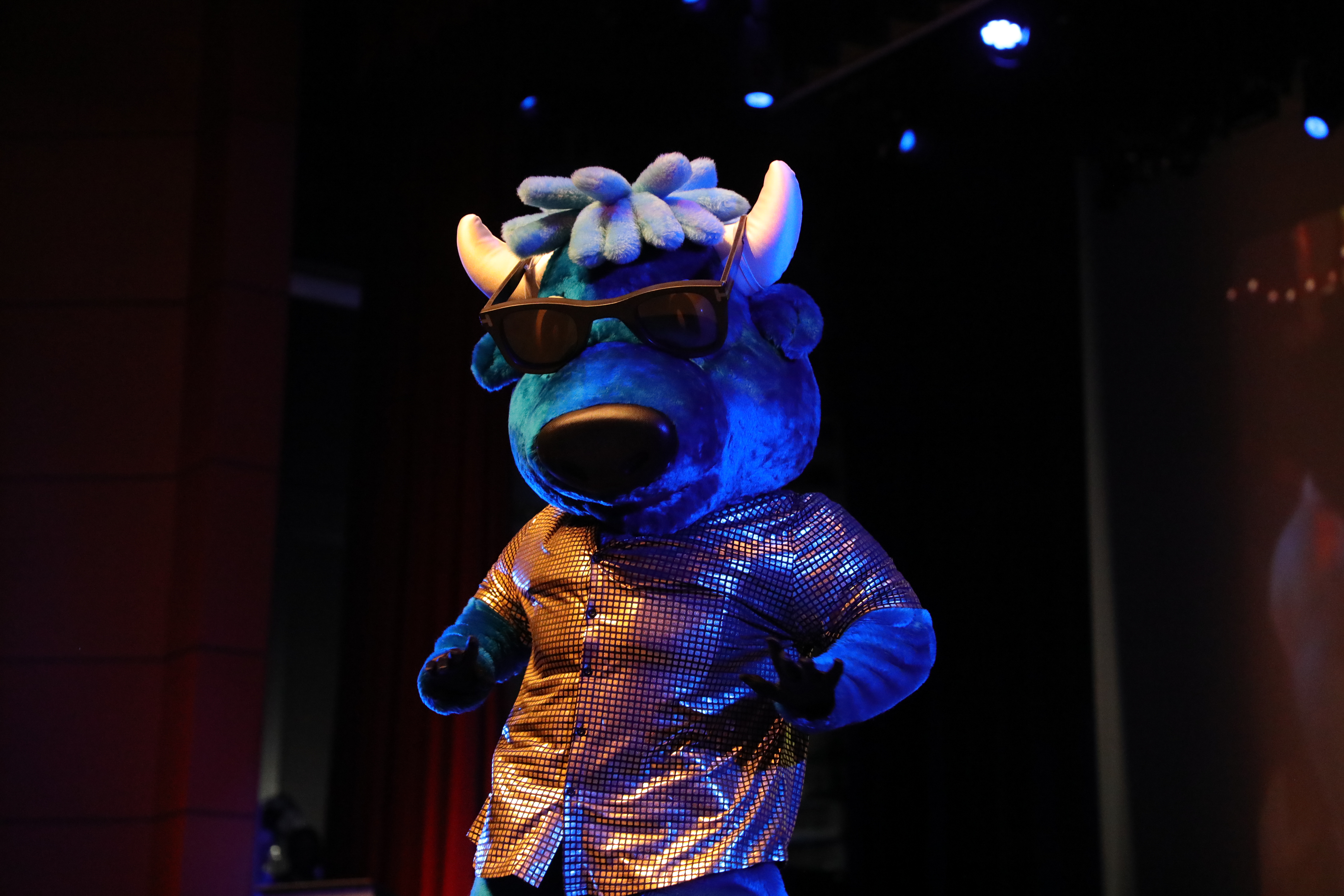 Mav the mascot dancing on stage at Harbison Theatre.