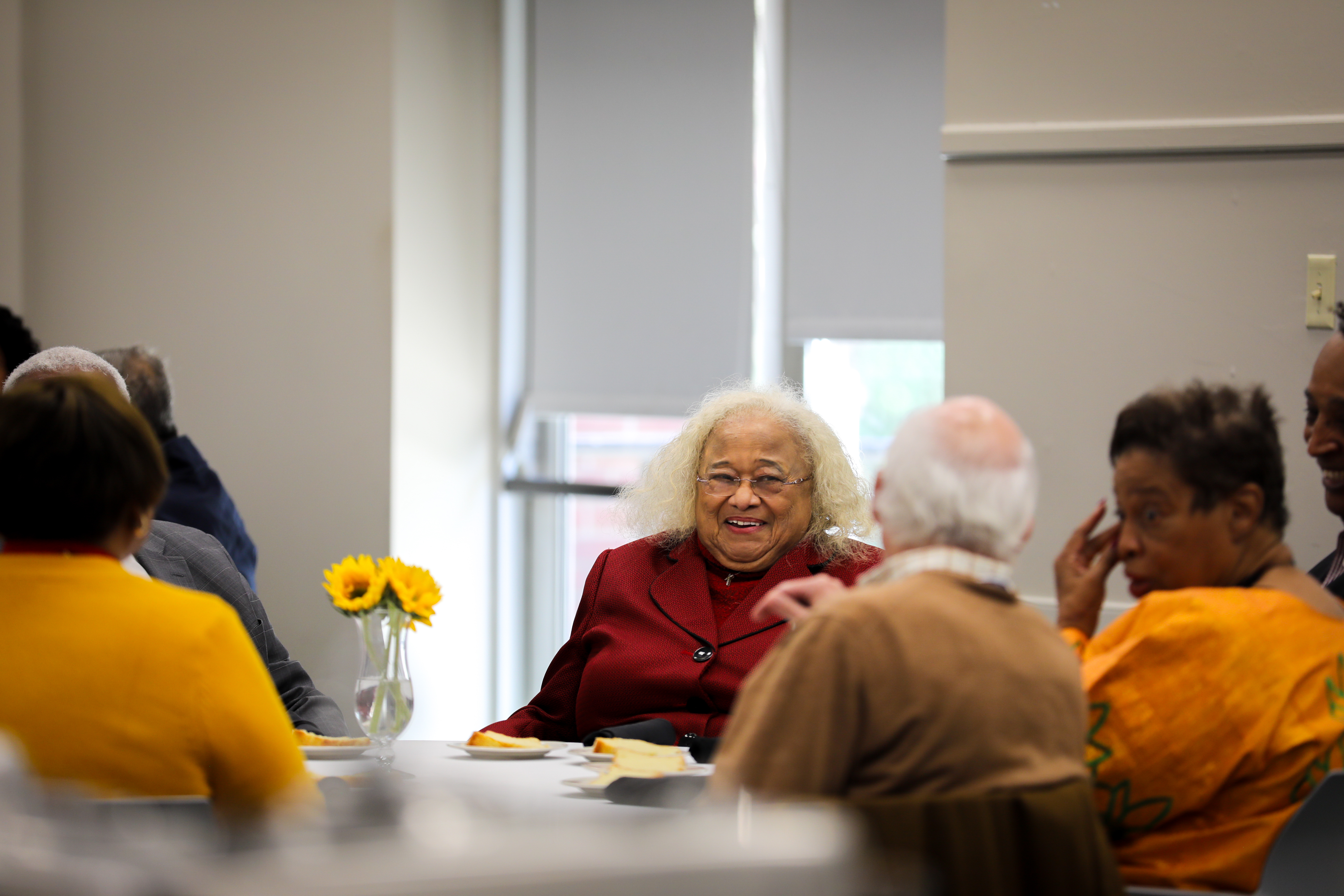 A graduate of the Harbison Institute laughing with other attendees.