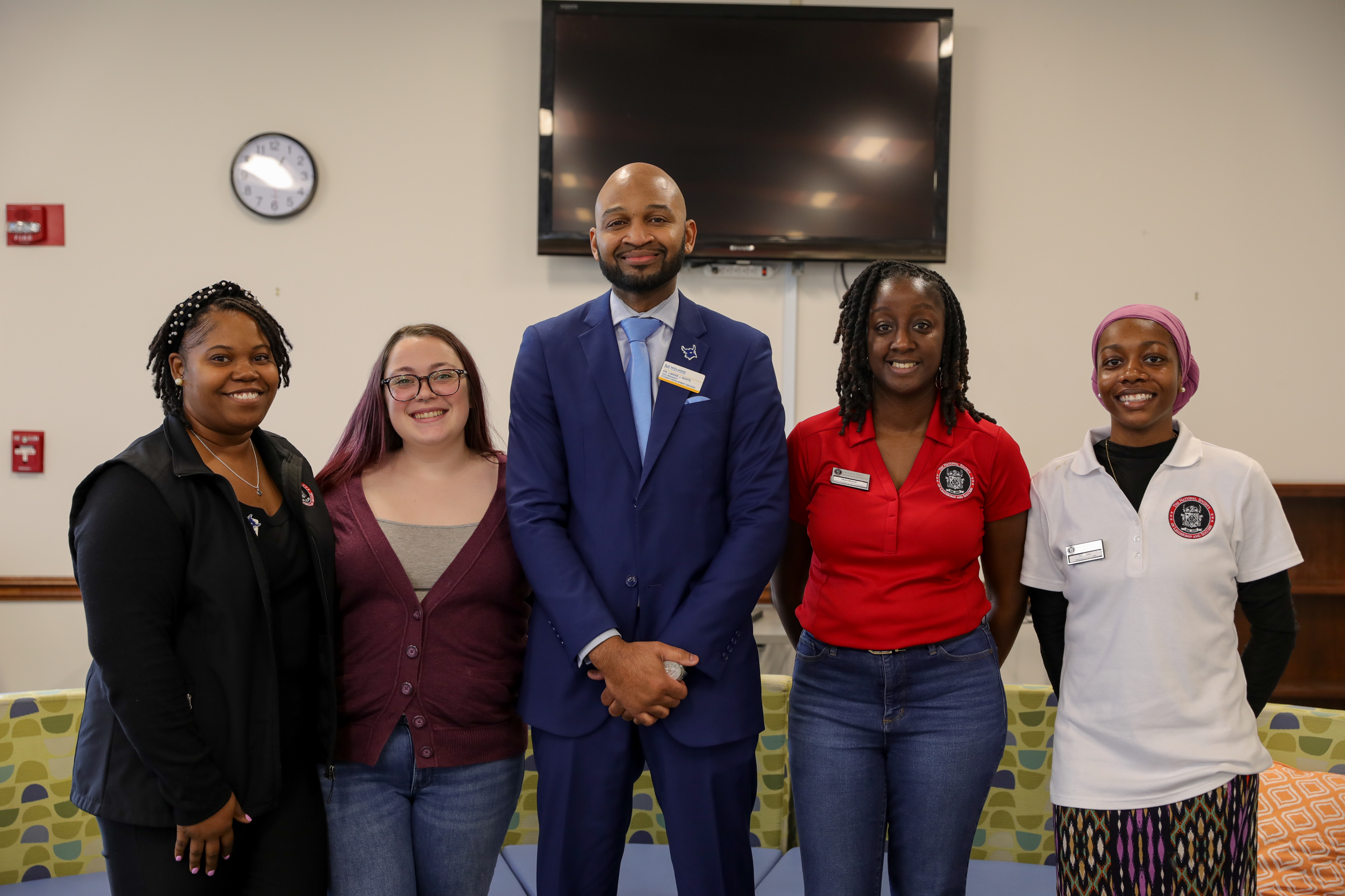 MTC students standing with the Vice President of Student Affairs on campus.