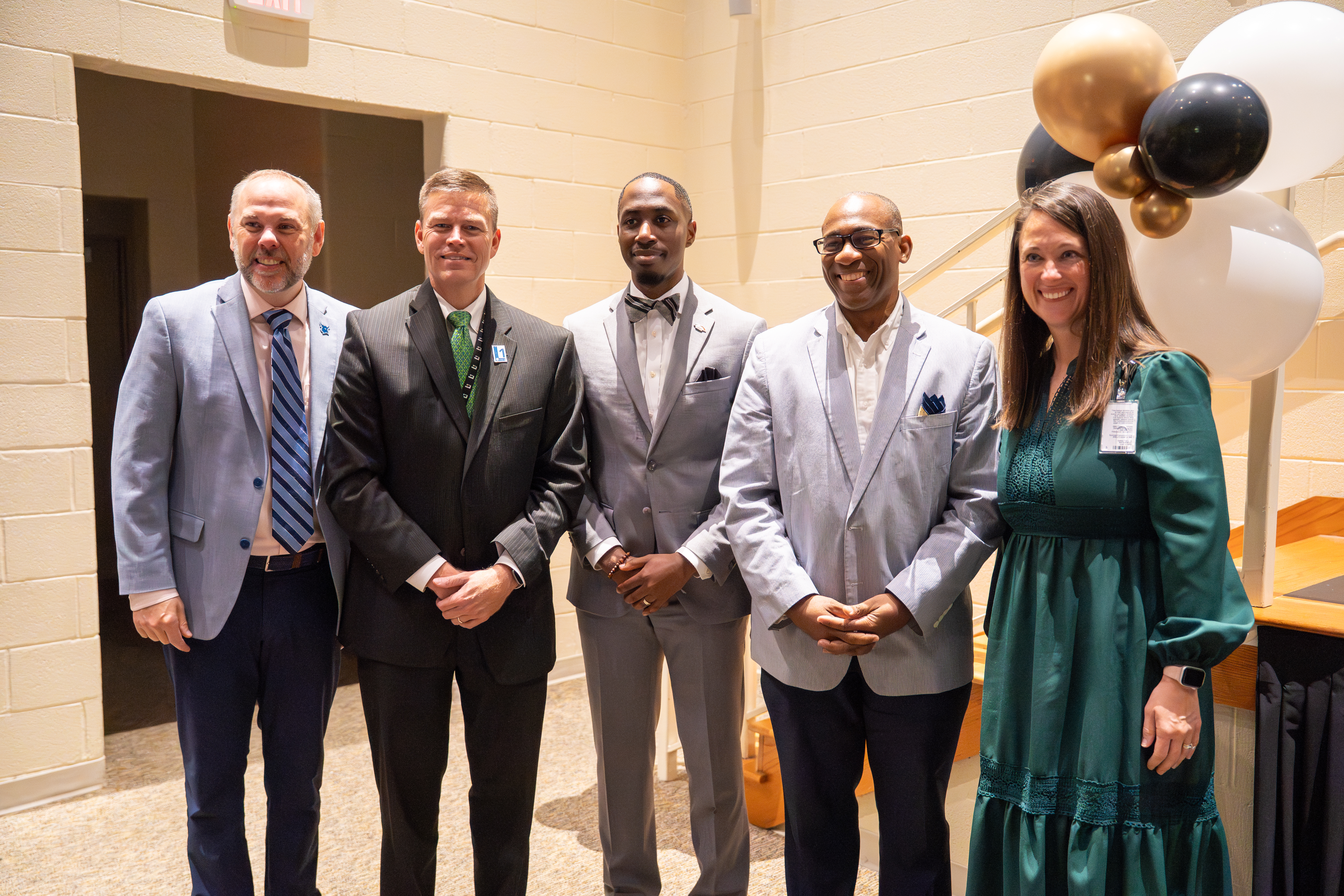 MTC President, Greg Little, College Center Director, Brandon Baskett, and other leaders stopping for a photo.