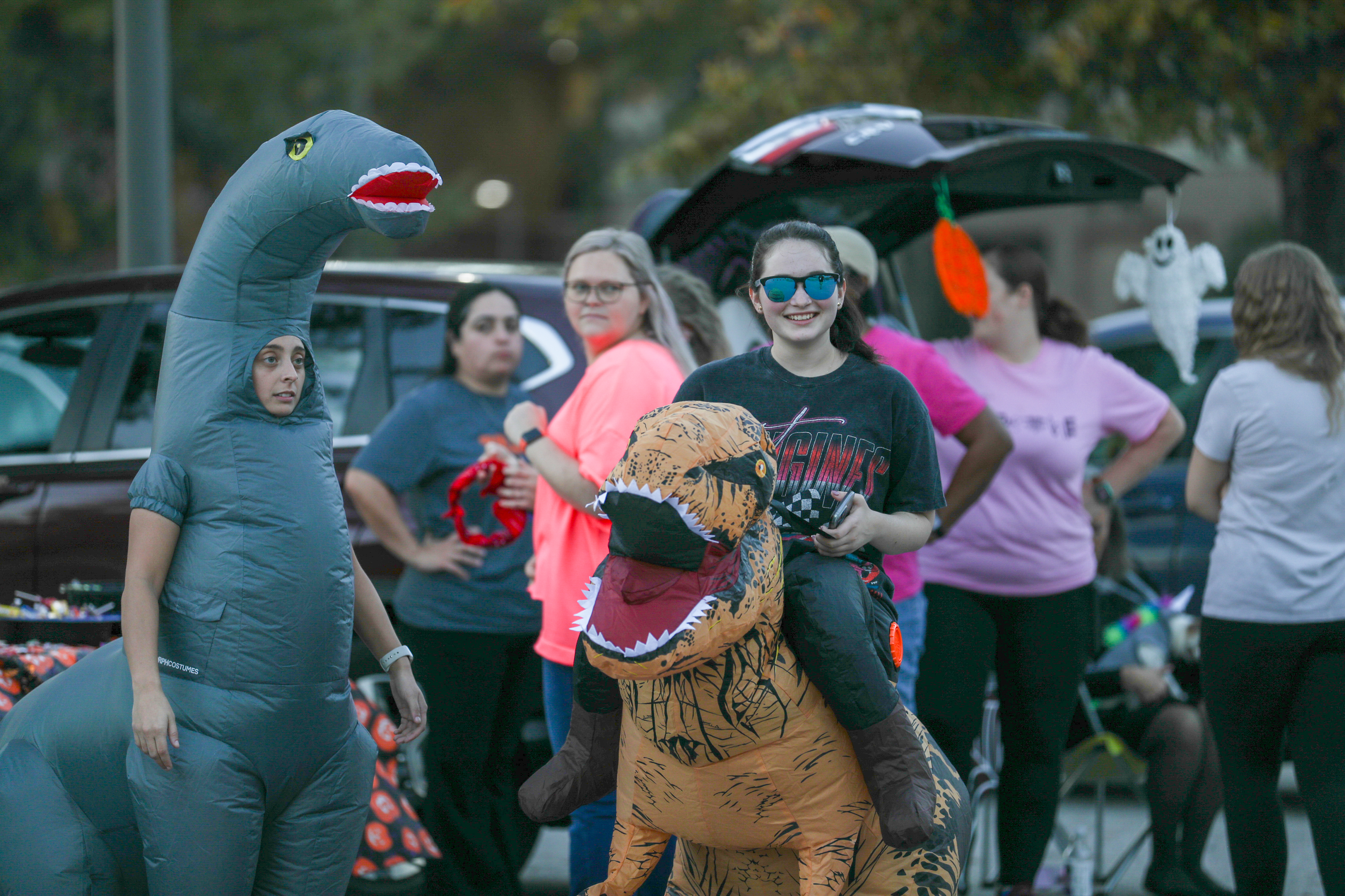 Students in costumes at a Halloween "trunk or treat" event on campus.
