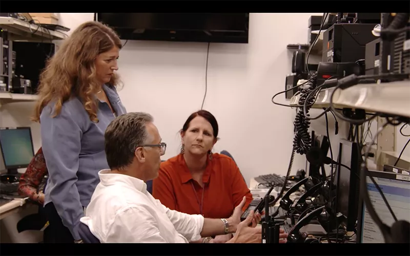 Three people monitoring call center