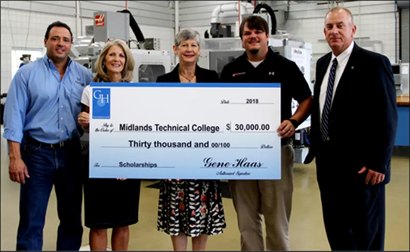 Group of people holding check from Gene Haas Foundation