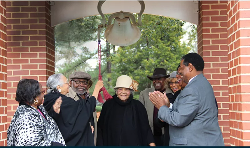 Dr. Rhames with Harbison Alumni Ringing Bell