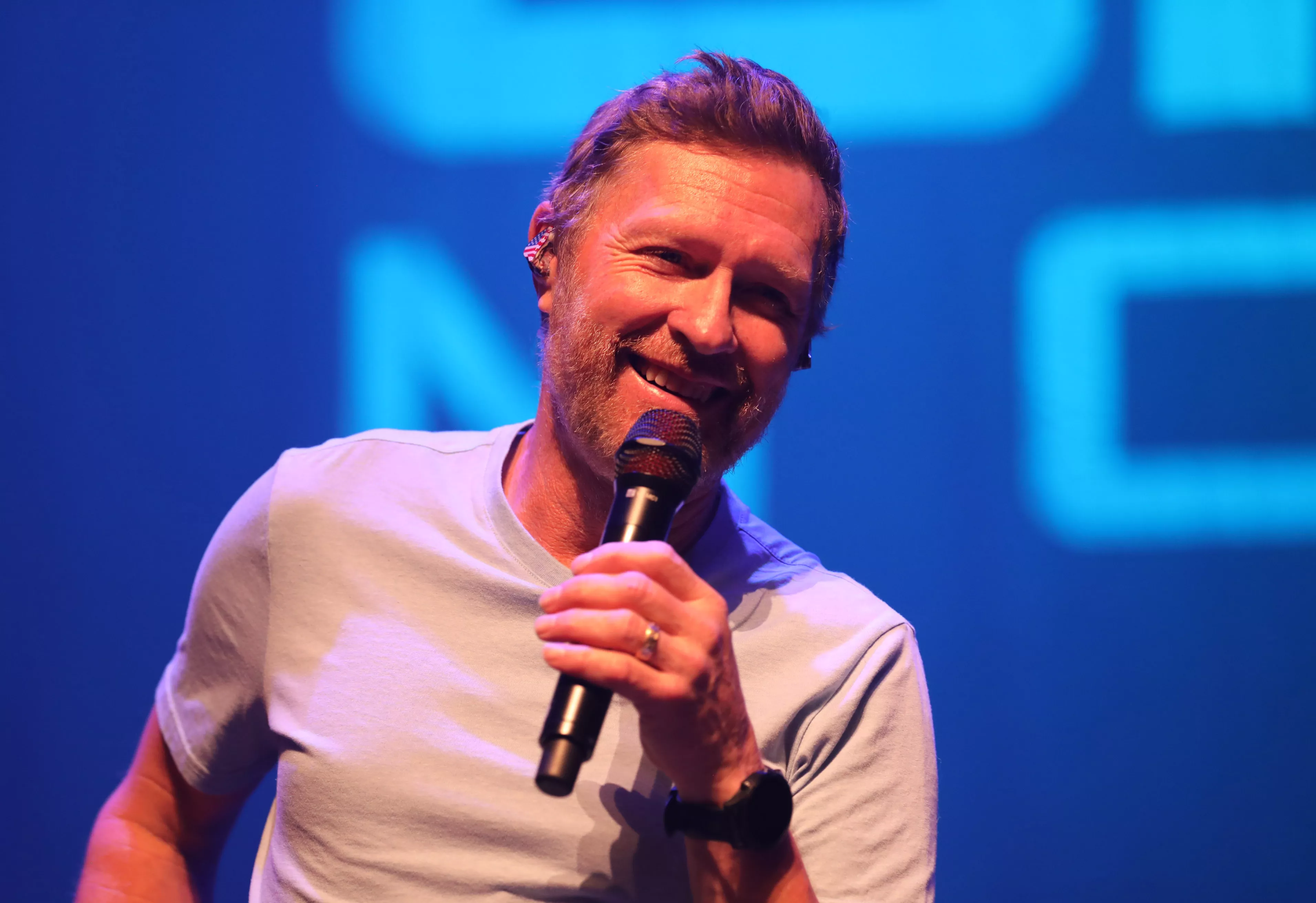 Craig Morgan smiling and holding microphone