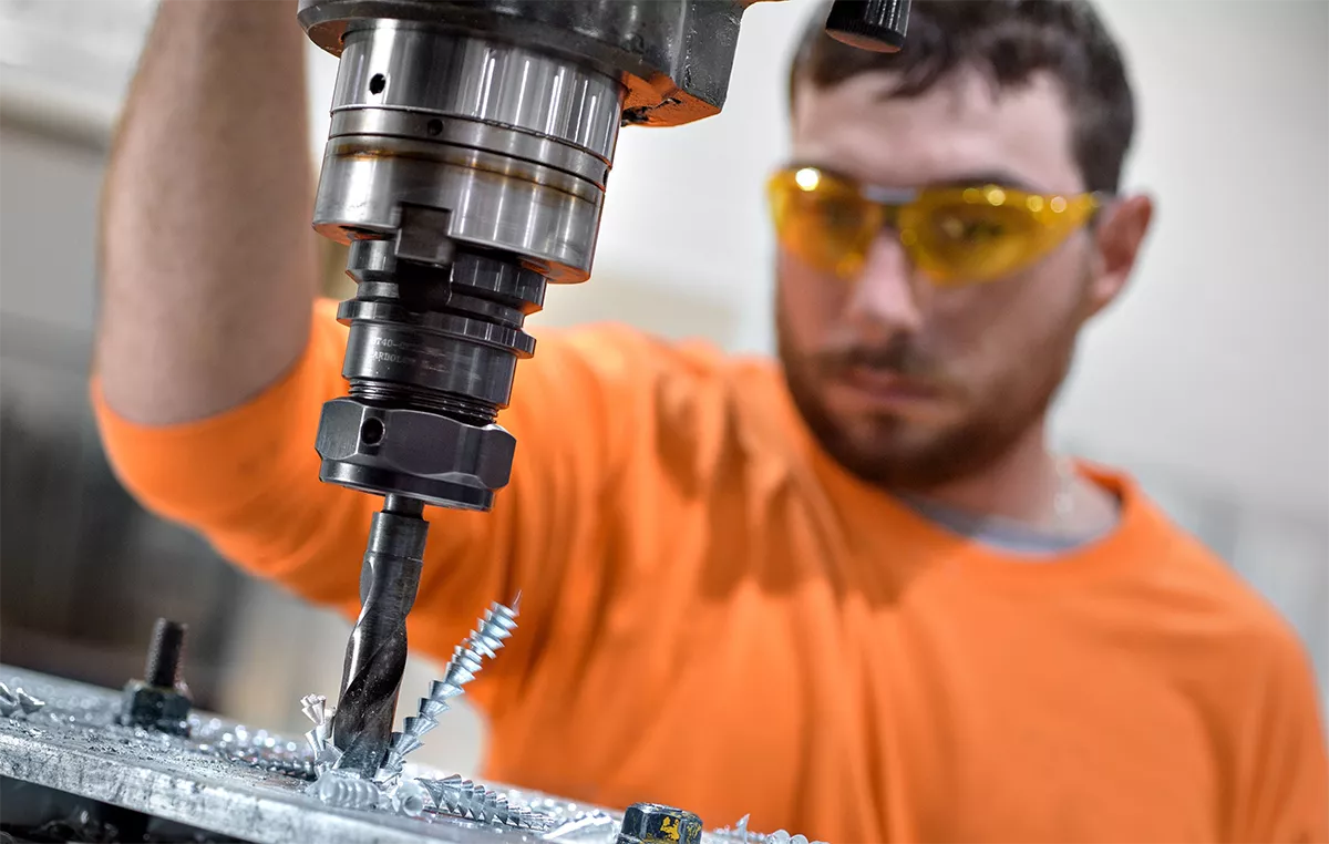 Student using a drill press