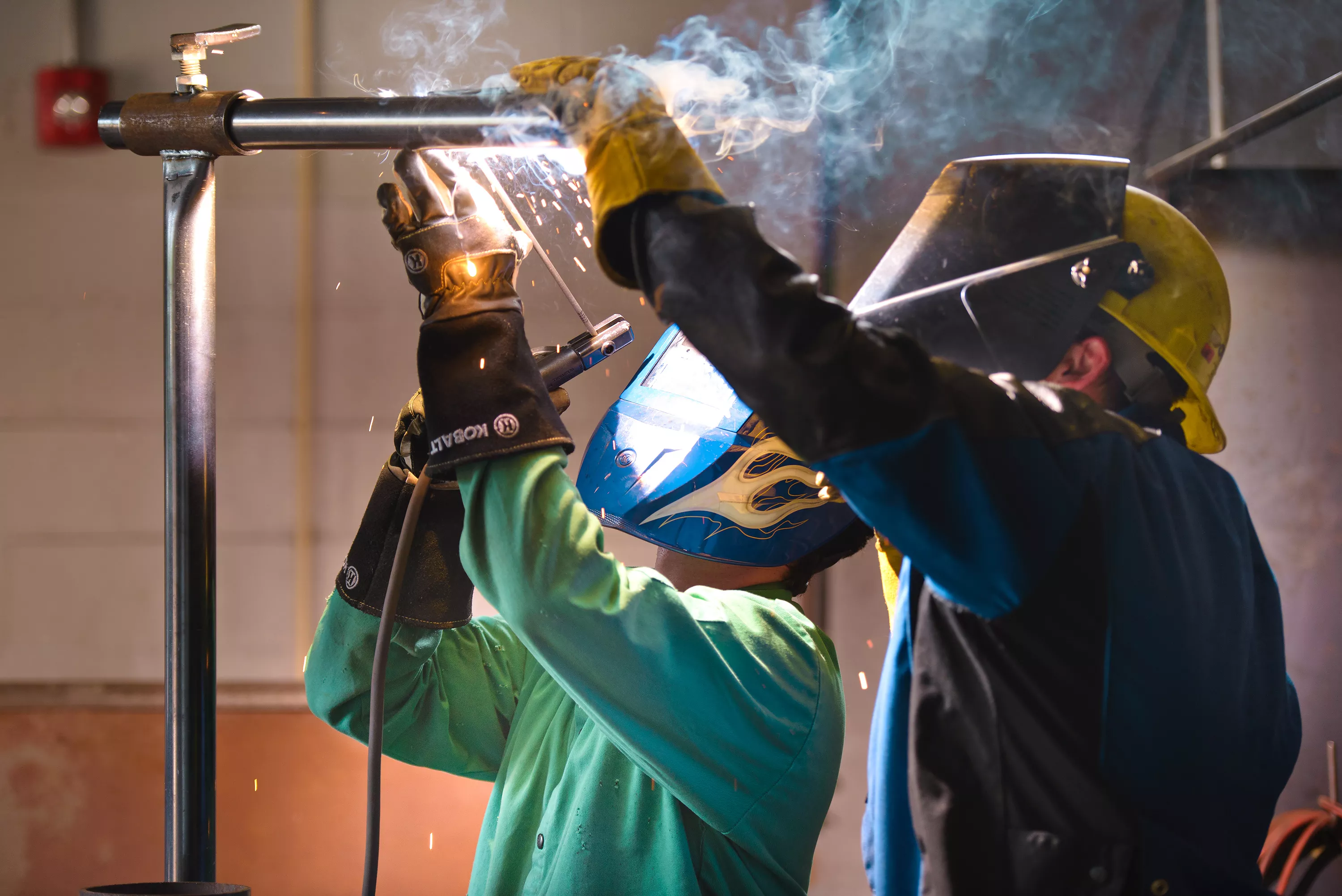 Two students welding