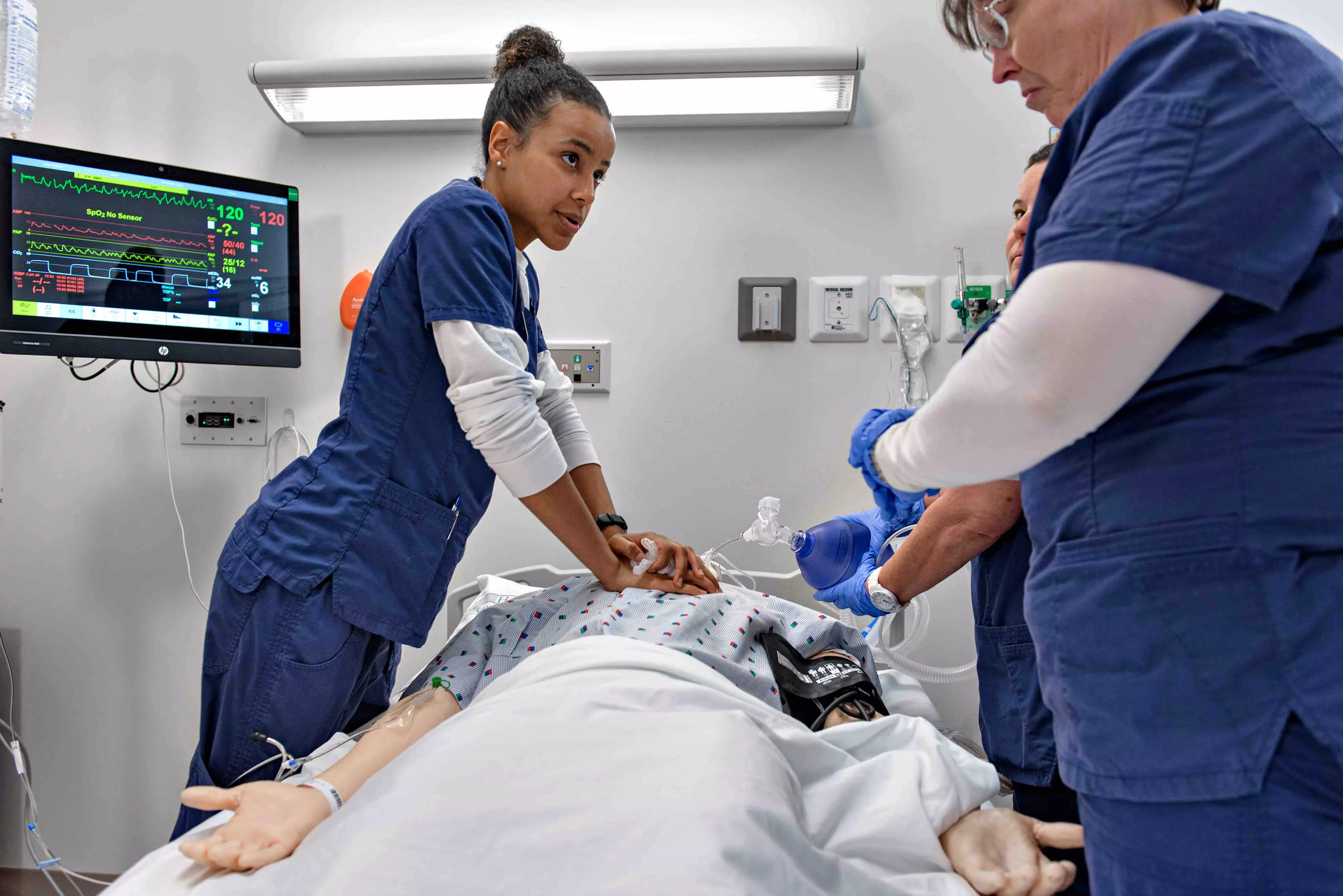 Nursing school students working on simulation patient