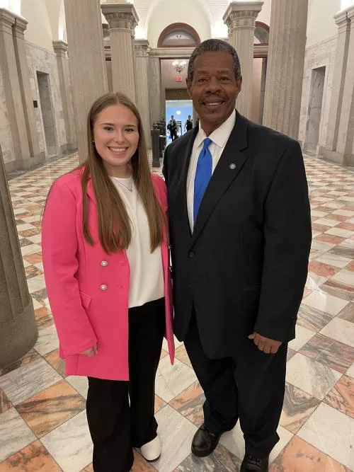 Geena Rocanella and Dr. Ronald Rhames stand in the state house lobby.