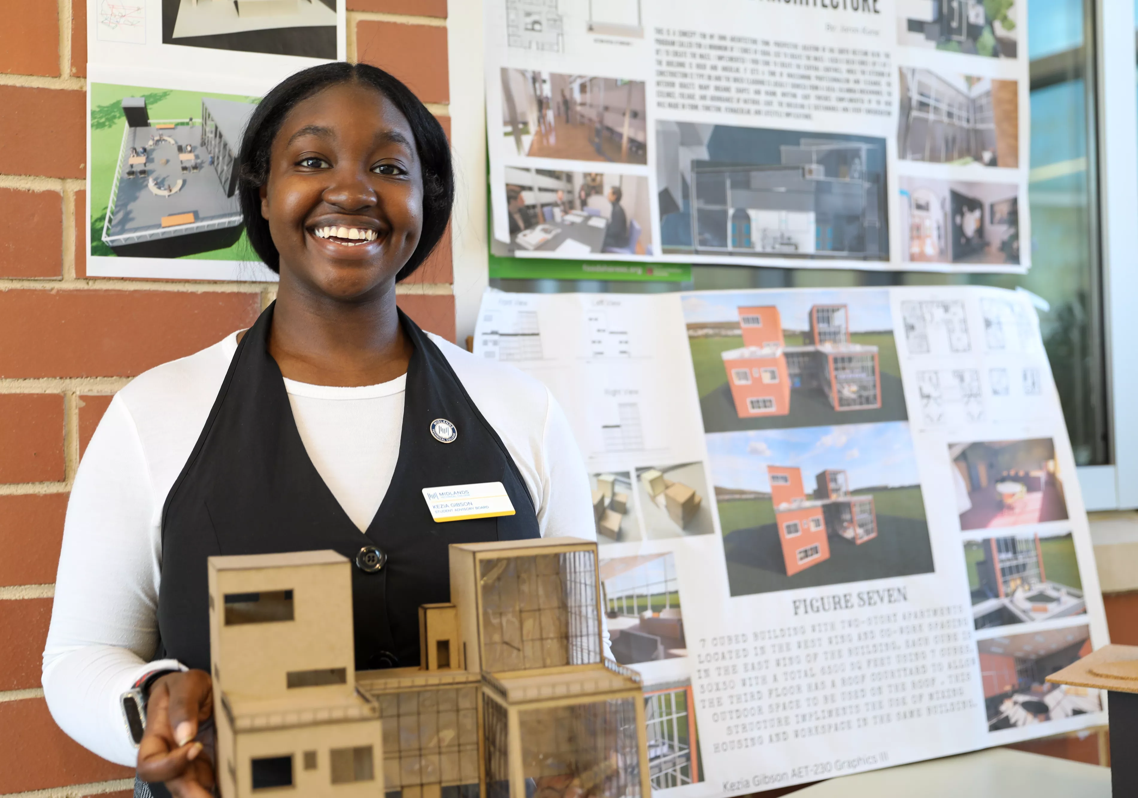 Image of an MTC student hold a house mockup at the 2024 Engineering Expo