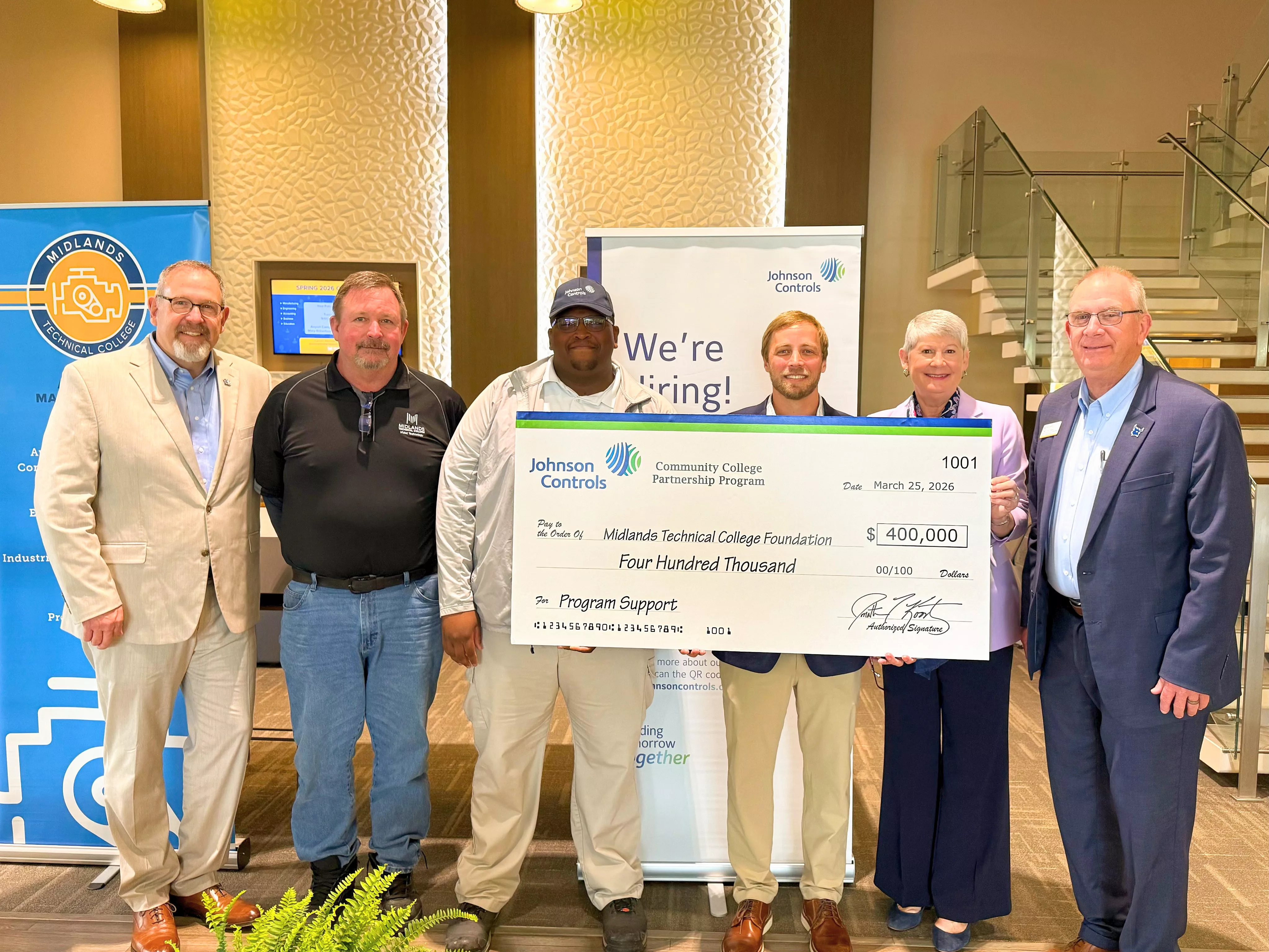 photo of johnson controls and midlands tech leadership with 400,000 check