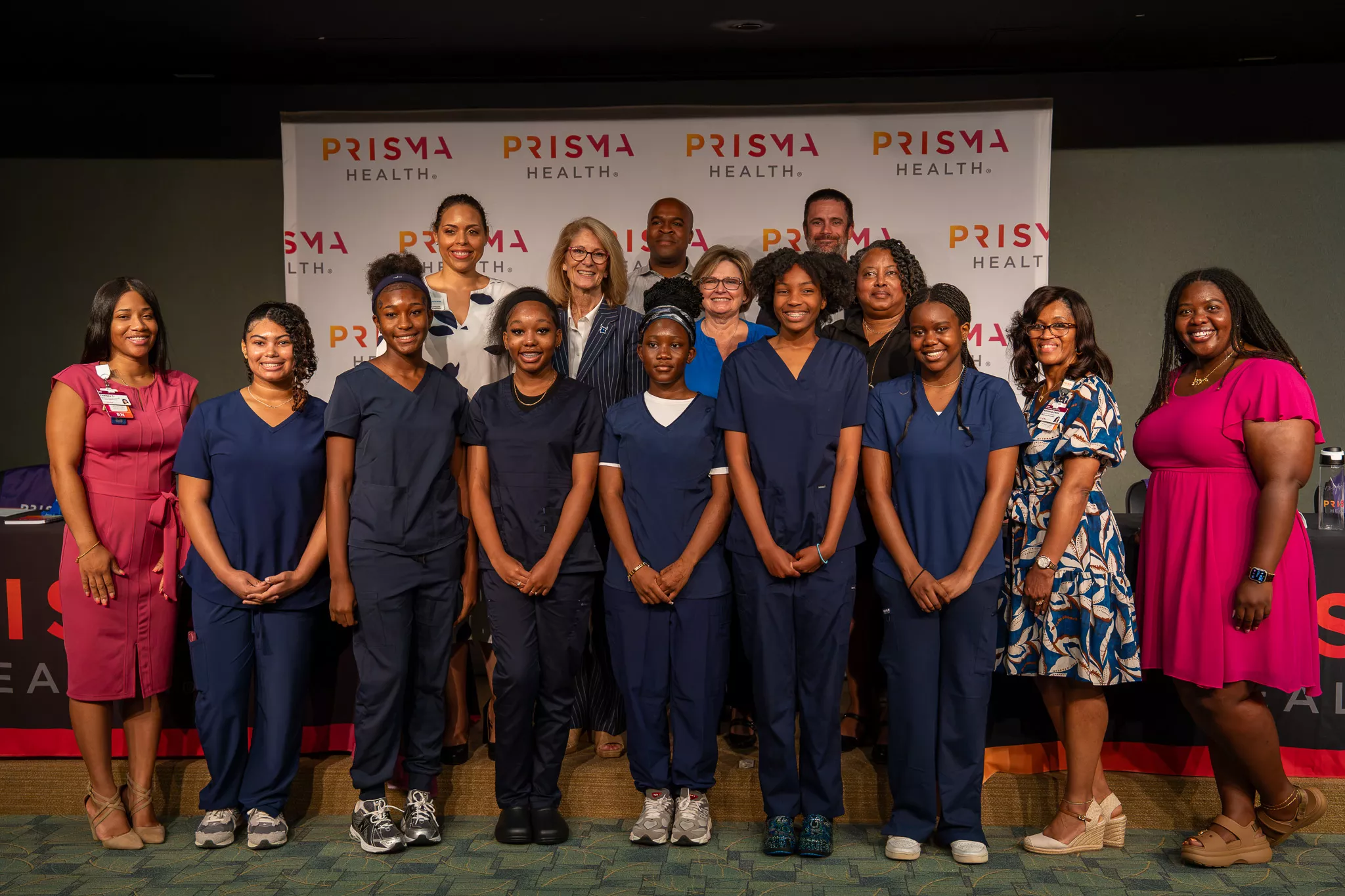 Students and members of the partnerships standing for a picture together.